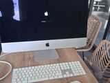 a computer sitting on a wooden desk with a keyboard and mouse