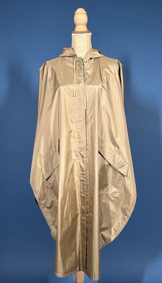 an image of a gold rain coat on a mannequin stand