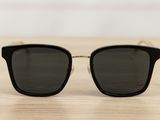 a pair of black sunglasses sitting on top of a wooden table