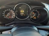 a close up of a car dashboard with gauges and a steering wheel