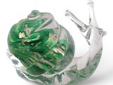 a glass snail with a green shell on it ' s back