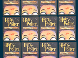 many harry potter books lined up on a blue background