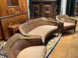 a room with a lot of wicker furniture in it
