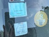 a sticker on the windshield of a car that has a lot of stickers on it