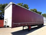 a semi trailer that is parked in a parking lot