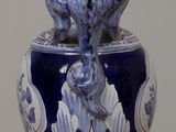 a blue and white vase with a fish on it