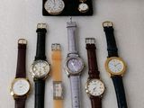 a lot of watches that are sitting on a table
