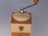 a small coffee grinder sitting on a white surface