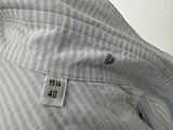 a close up of a blue and white shirt with a tag on it