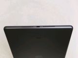 the back of a black laptop computer sitting on top of a table