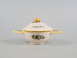 underside view of a tureeny dish with a lid in the shape of a bird