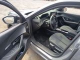 the interior of a car with the door open and the driver ' s seat down