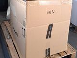 a cardboard box sitting on a pallet in a garage