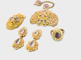 a lot of gold jewelry on a white surface