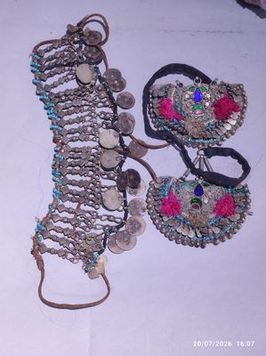 two pieces of jewelry that are on a table