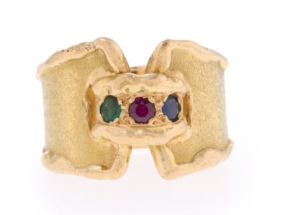 a close up of a gold ring with multi colored stones