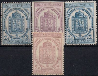 four different stamps of different colors and designs on a black surface