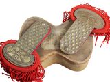 an old pair of shoes with red fringes on a white background