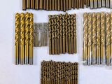 a lot of drill bits that are laying out on a table