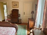 a bedroom with a bed and a chair in it