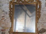 a mirror sitting on top of a table next to a brick wall