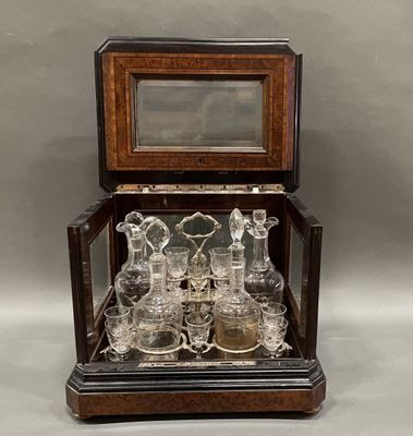 an antique glass and wood display case with a mirror on top of it