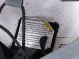 a piece of paper that has been pinned to the back of a bag