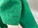 green jacket with white collar and cuffs on a mannequin mannequin mannequin mannequin mannequin mannequin mannequin manne