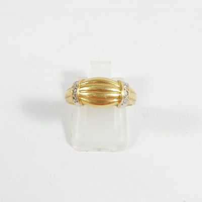 gros plan d'une bague en or sur une surface blanche