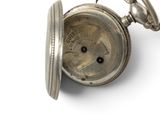 a silver pocket watch on a white surface with a white background