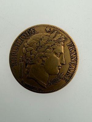 an old gold coin with a woman ' s head on it