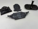 three pieces of metal on a white surface