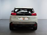 the rear end of a white suv parked in a white room