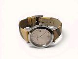 an image of a close up of a wrist watch on a white surface
