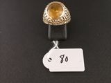a close up of a ring with a tag on a table