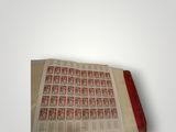 an open book with a red cover sitting on top of a table
