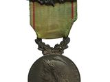 an old medal on a white background with a ribbon around it