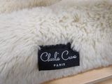 a close up of a teddy bear bed with a label on it