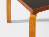 the table is made of wood and has a black top