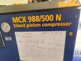 a machine that has a sign on the side of it that says mck 988000 n silent piston compressor