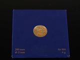 a close up of a blue box with a gold coin on it