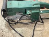 a green machine that is sitting on the floor