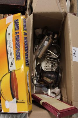a cardboard box full of kitchen utensils and cookware