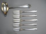 six silver spoons and six silver spoons on a table