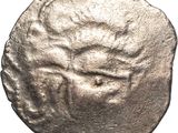 une vieille pièce d'argent sur laquelle est représenté un visage