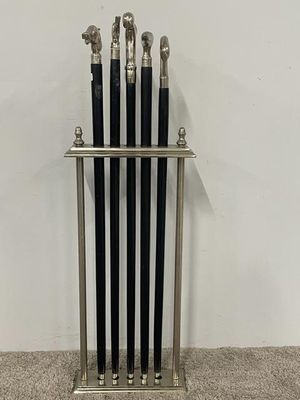a metal rack with five umbrellas on top of it