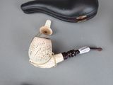 a picture of a pipe and a pair of shoes on a table