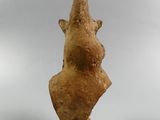 an ancient statue of a woman ' s head on a wooden base