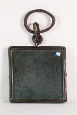 a small metal object hanging on the wall