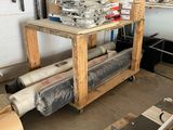 many rolls of plastic sitting on top of a wooden table
